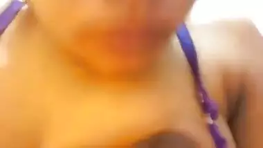 Wife in a blue sex bra takes a XXX Indian tit out and squeezes it